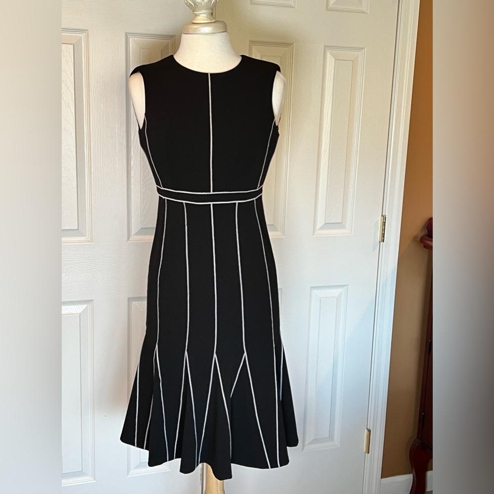 Calvin Klein crew neck black dress with white stripes with faired bottom.